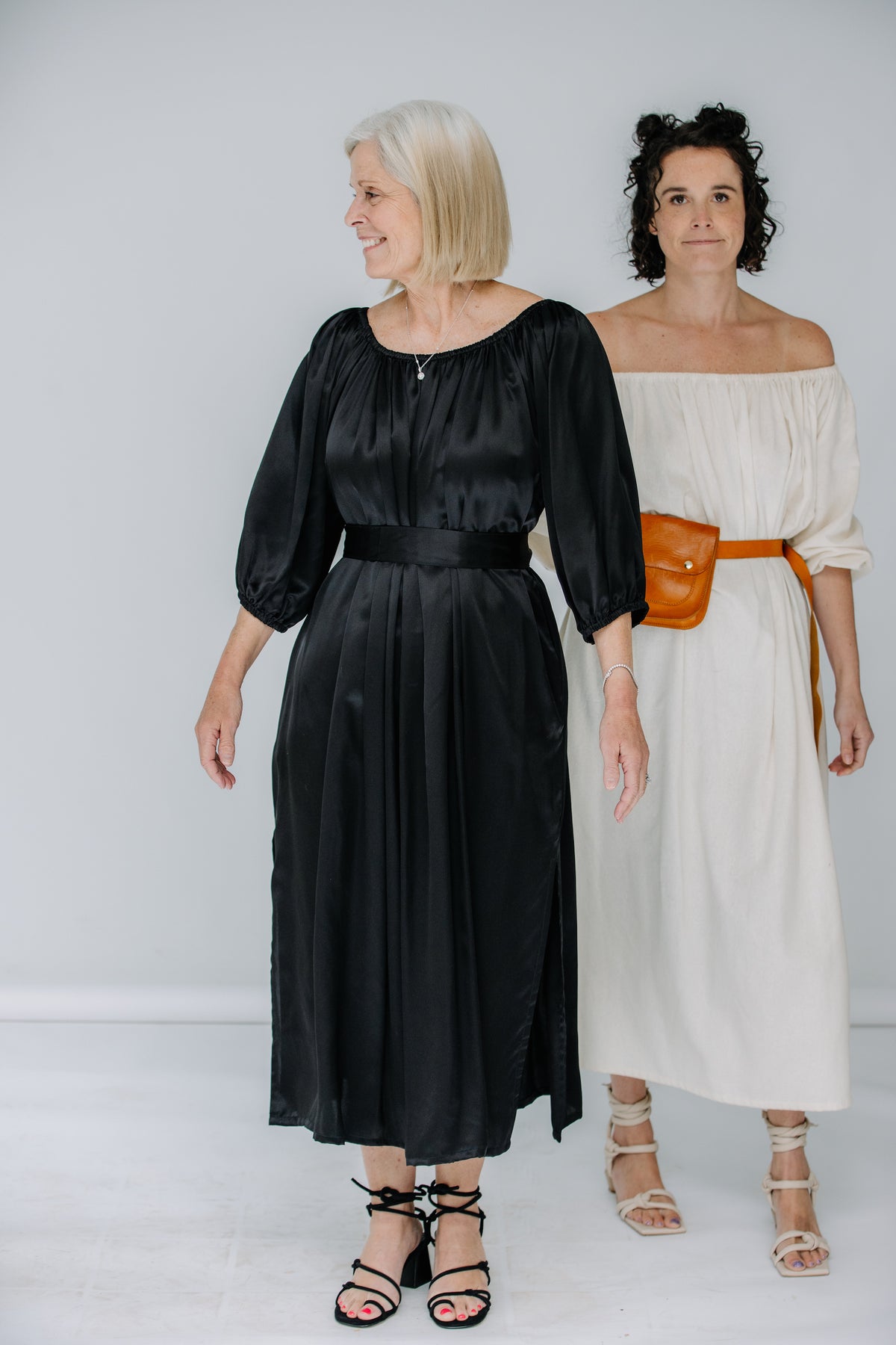 jules and lacey wear the cassatt dress in raw silk in natural, and venita wears the cassat dress in black silk charmeuse. dresses by miranda bennett studio