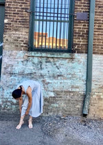 phoebe has dark brown hair and wears the alabama chanin hand sewn cynthia tank dress with a dropped waist in sky blue organic cotton