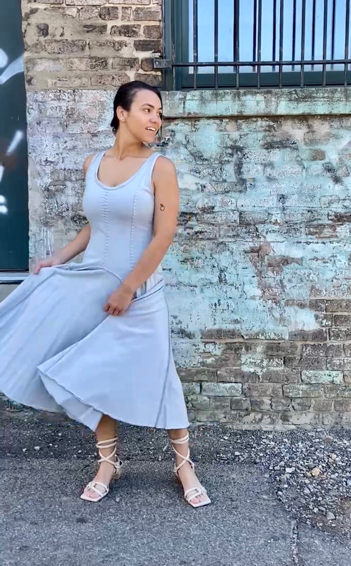 phoebe has dark brown hair and wears the alabama chanin hand sewn cynthia tank dress with a dropped waist in sky blue organic cotton