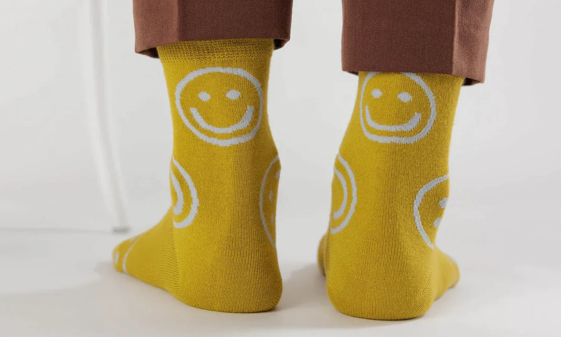 detailed shot of the baggu crew socks in the yellow happy face print