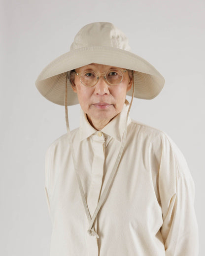 a woman wears the soft sun hat in beige