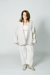marisa, a white woman, wears the alabama chanin ivory corset top with miranda bennett kusama pants. she&