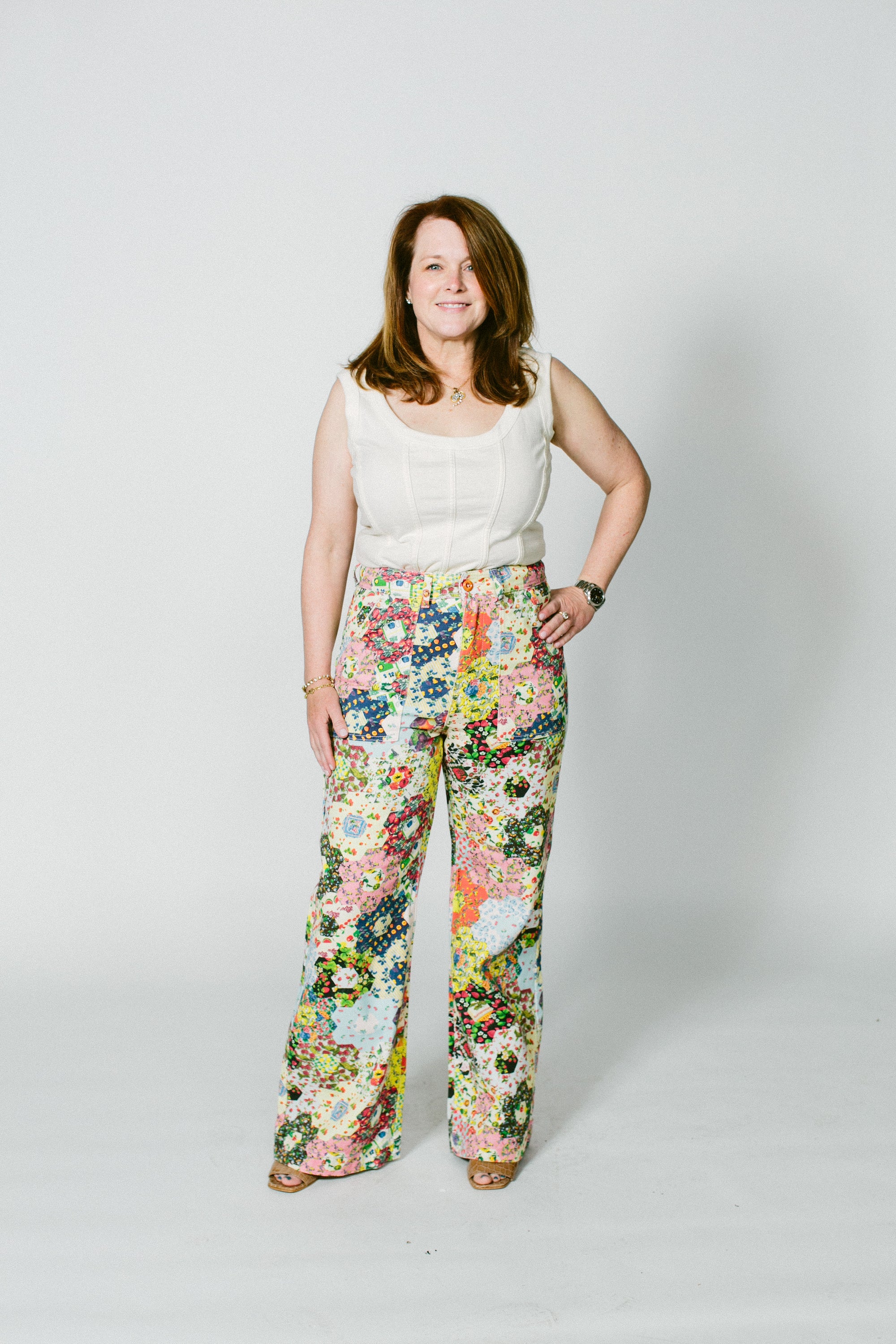 marisa, a white woman, wears the alabama chanin ivory corset top with some over the top floral rachel antonoff pants.