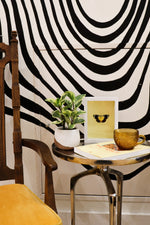 a yellow and black butterfly framed in a white frame with lemon backing sits on an occassional table